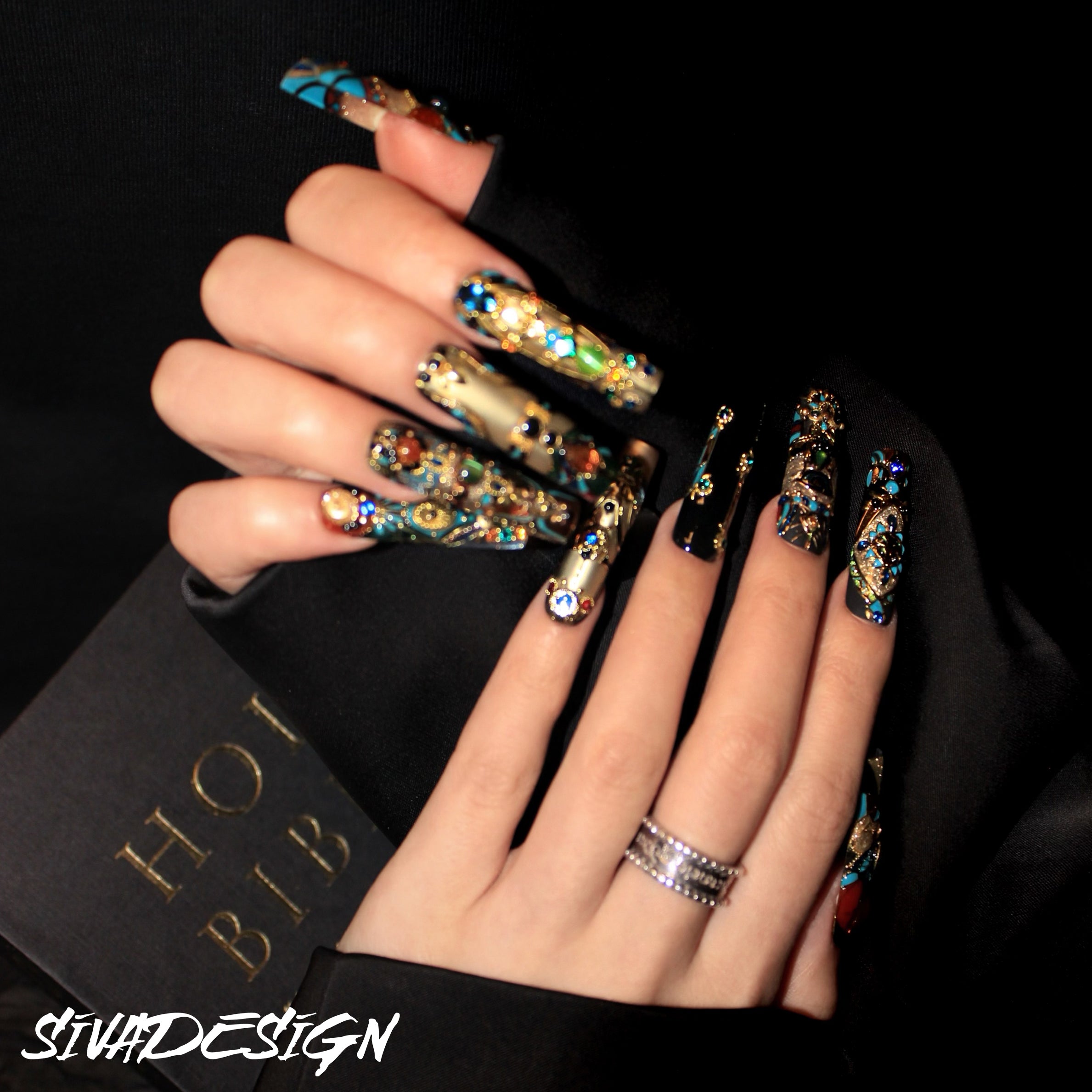 High-quality custom press-on nails with detailed designs and luxurious gemstone accents in vibrant colors