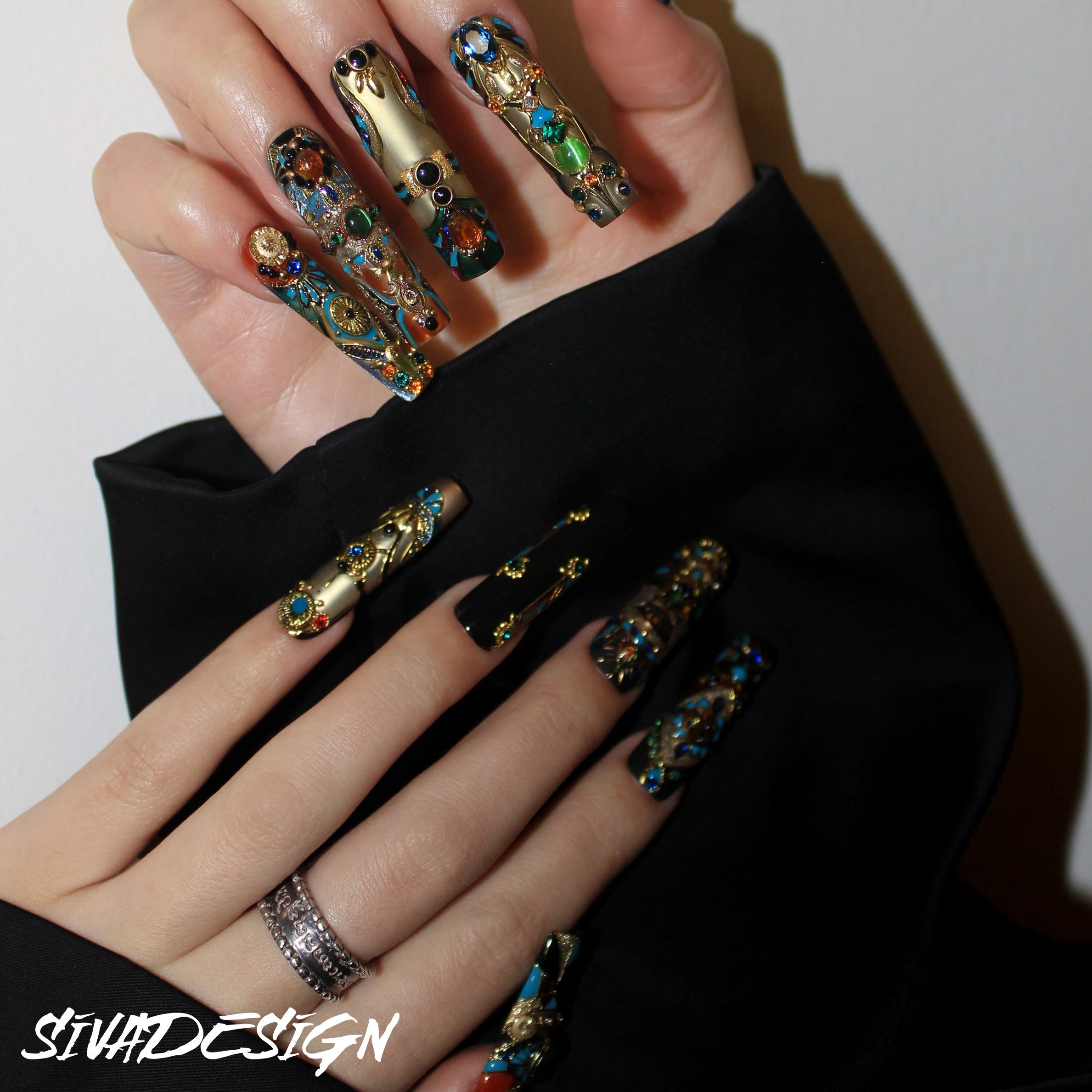 Artistic luxury press-on nails showcasing metallic finishes and detailed embellishments for a glamorous look