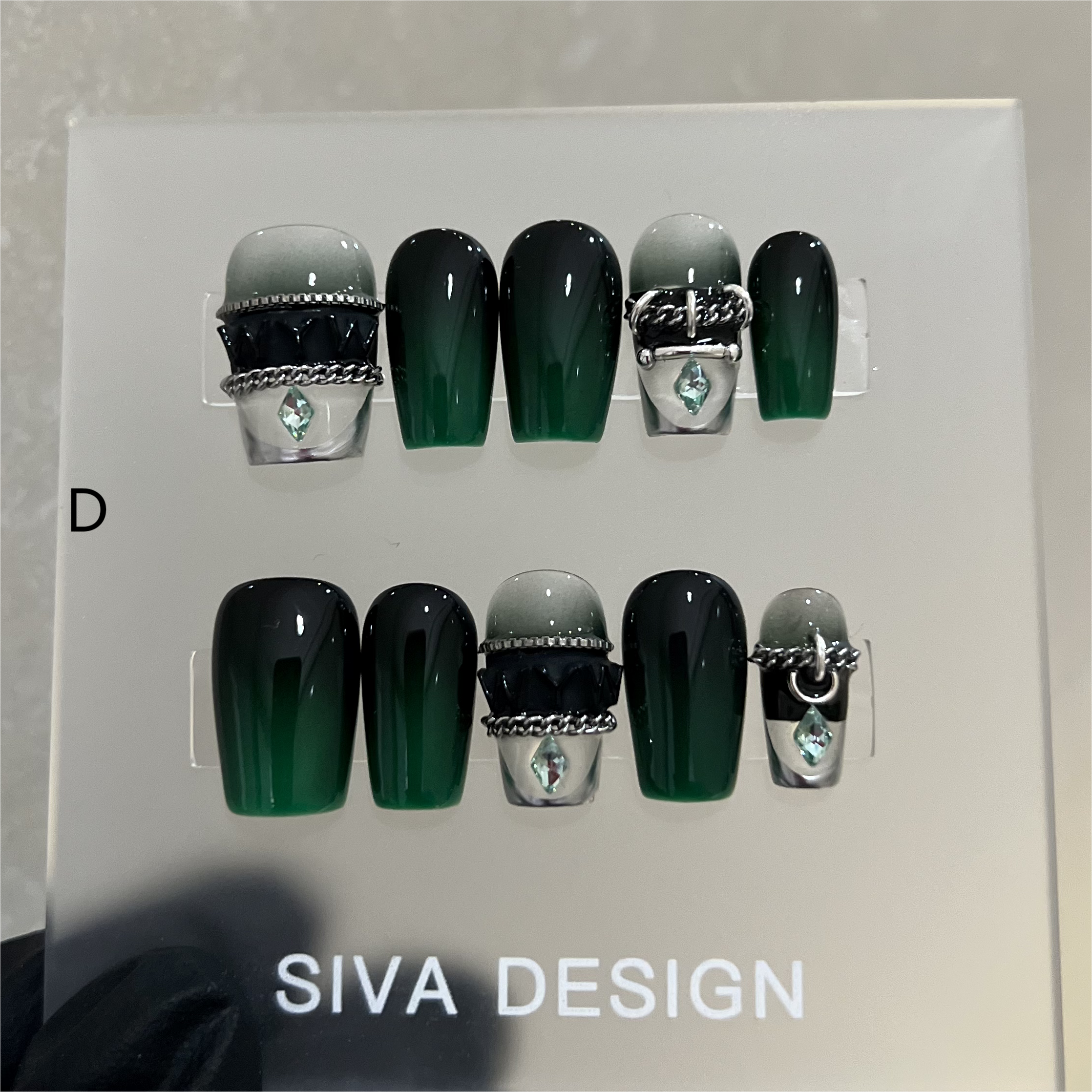 Stylish green and silver nail designs featuring natural resin gel nails